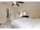 Bedroom with en suite bathroom, plush bed, and a comfortable green sofa at 10610 Kingsmark Trl, Alpharetta, GA 30022
