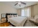 Bedroom featuring a plush bed, ample natural light, and a cozy rocking chair at 10610 Kingsmark Trl, Alpharetta, GA 30022