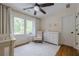 Bright Bedroom featuring wood floors, rocking chair, and a window at 10610 Kingsmark Trl, Alpharetta, GA 30022
