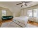 Bedroom featuring a plush bed, natural light, and a comfortable green sofa at 10610 Kingsmark Trl, Alpharetta, GA 30022