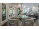 Breakfast nook showcasing a glass table and seating, with a view of the modern kitchen at 10610 Kingsmark Trl, Alpharetta, GA 30022