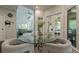 Cozy breakfast nook with a glass table and seating adjacent to a sunny porch and living area at 10610 Kingsmark Trl, Alpharetta, GA 30022