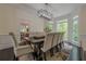 Formal dining room with large windows and a contemporary chandelier at 10610 Kingsmark Trl, Alpharetta, GA 30022