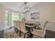 Elegant dining room with views of the outside and seating for eight at 10610 Kingsmark Trl, Alpharetta, GA 30022