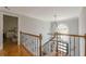 Bright foyer features decorative staircase and chandelier at 10610 Kingsmark Trl, Alpharetta, GA 30022