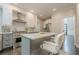 Well-lit kitchen with stainless steel appliances, a center island with bar stools, and bright lighting at 10610 Kingsmark Trl, Alpharetta, GA 30022