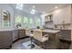 Contemporary kitchen with an island, seating, stainless steel appliances, and large arched windows overlooking the yard at 10610 Kingsmark Trl, Alpharetta, GA 30022