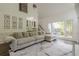 Spacious living room featuring a large sectional sofa, a built-in bar area, and a view of the backyard at 10610 Kingsmark Trl, Alpharetta, GA 30022