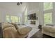 Bright living room with large windows, a fireplace, and comfortable seating at 10610 Kingsmark Trl, Alpharetta, GA 30022