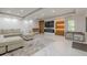 Modern living room featuring marble floors, recessed lighting, electric fireplace and custom entertainment center at 10610 Kingsmark Trl, Alpharetta, GA 30022