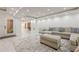 Spacious living room featuring sofa, large rug, marble floors and access to backyard at 10610 Kingsmark Trl, Alpharetta, GA 30022