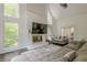 Bright living room featuring large windows, fireplace, and a comfortable sectional sofa at 10610 Kingsmark Trl, Alpharetta, GA 30022