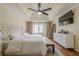 Bright main bedroom features a tray ceiling, ceiling fan, and an abundance of natural light at 10610 Kingsmark Trl, Alpharetta, GA 30022