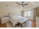 Bright main bedroom features tray ceilings, ceiling fan, and a white shag rug at 10610 Kingsmark Trl, Alpharetta, GA 30022