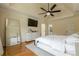 Bright main bedroom with hardwood floors and a modern ceiling fan at 10610 Kingsmark Trl, Alpharetta, GA 30022