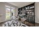 Office space featuring a sleek desk and a large, custom bookcase perfect for storage and display at 10610 Kingsmark Trl, Alpharetta, GA 30022
