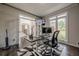 Bright office space featuring a modern desk setup, large windows, and view of front lawn at 10610 Kingsmark Trl, Alpharetta, GA 30022