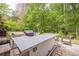 Outdoor kitchen featuring a built-in grill, countertop space, and bar seating, ideal for entertaining at 10610 Kingsmark Trl, Alpharetta, GA 30022