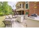 Entertain on a cozy outdoor patio with a full kitchen, fireplace, and comfortable seating arrangements at 10610 Kingsmark Trl, Alpharetta, GA 30022