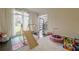 Sunlit playroom featuring an indoor slide, swing, and trampoline for active play at 10610 Kingsmark Trl, Alpharetta, GA 30022