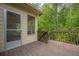 A screened porch features a view of the wooded backyard at 10610 Kingsmark Trl, Alpharetta, GA 30022