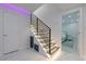 Staircase with modern design, featuring LED lighting, black metal railings, and access to another bedroom at 10610 Kingsmark Trl, Alpharetta, GA 30022