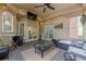 Bright sunroom featuring a tv, ceiling fan, overhead lighting, and access to a covered outdoor deck at 10610 Kingsmark Trl, Alpharetta, GA 30022