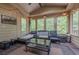 A sunroom featuring a comfortable seating area and abundant natural light, perfect for relaxation at 10610 Kingsmark Trl, Alpharetta, GA 30022