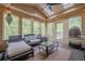 A sunroom with skylights, plenty of seating, and a view of the backyard at 10610 Kingsmark Trl, Alpharetta, GA 30022