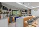 Modern wet bar with custom shelving, under-counter refrigerator, marble counters and stylish seating at 10610 Kingsmark Trl, Alpharetta, GA 30022