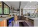 Stylish wet bar featuring glass shelves, beverage coolers, custom cabinets, and stone countertops at 10610 Kingsmark Trl, Alpharetta, GA 30022