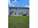 Large backyard with a grass lawn and a view of the two-story home at 221 Eleanora Way, Loganville, GA 30052