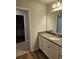 Clean bathroom with a large mirror and a neutral-colored vanity at 221 Eleanora Way, Loganville, GA 30052