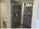 Modern shower with gray tile, a glass door, and built-in shelving at 221 Eleanora Way, Loganville, GA 30052