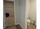 View into the bathroom including a toilet and a peak into a walk-in closet at 221 Eleanora Way, Loganville, GA 30052