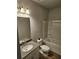 Well-lit bathroom featuring a shower-tub combo and a vanity with a sink and storage at 221 Eleanora Way, Loganville, GA 30052