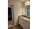 Bright bathroom boasts a quartz vanity and spacious countertop, plus wood-look flooring at 221 Eleanora Way, Loganville, GA 30052