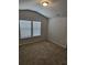 Bedroom featuring a large window that provides natural light and neutral carpeting at 221 Eleanora Way, Loganville, GA 30052