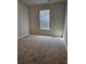 Cozy bedroom featuring neutral carpeting, one window, and ample natural light at 221 Eleanora Way, Loganville, GA 30052