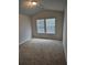 Bedroom featuring high ceilings, a window, and neutral carpeting at 221 Eleanora Way, Loganville, GA 30052