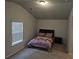 Cozy bedroom with vaulted ceilings, a comfortable bed, and a window with blinds at 221 Eleanora Way, Loganville, GA 30052