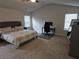 Spacious bedroom with a high ceiling, a comfortable bed, and a dedicated workspace at 221 Eleanora Way, Loganville, GA 30052