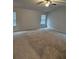 Spacious bedroom featuring neutral walls and carpet, with a ceiling fan for added comfort at 221 Eleanora Way, Loganville, GA 30052