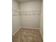 Neutral walk-in closet featuring carpeted flooring and metal racks at 221 Eleanora Way, Loganville, GA 30052