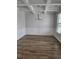 Formal dining room with coffered ceiling, wood-look floors, and paneled walls at 221 Eleanora Way, Loganville, GA 30052