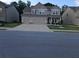 Charming two-story home with a well-maintained lawn and a spacious three car garage at 221 Eleanora Way, Loganville, GA 30052