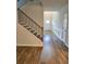 Entryway foyer featuring wood flooring, stairs, and wainscoting wall paneling at 221 Eleanora Way, Loganville, GA 30052