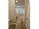 Open hallway with wood floors leading into the kitchen, dining, and living space at 221 Eleanora Way, Loganville, GA 30052