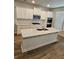 Bright kitchen featuring stainless steel appliances, a large island, and white cabinetry at 221 Eleanora Way, Loganville, GA 30052