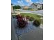 Close-up of the landscaping showing bushes, stones and vibrant flowering plants at 221 Eleanora Way, Loganville, GA 30052